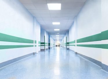 long corridor in hospital with doors and reflections